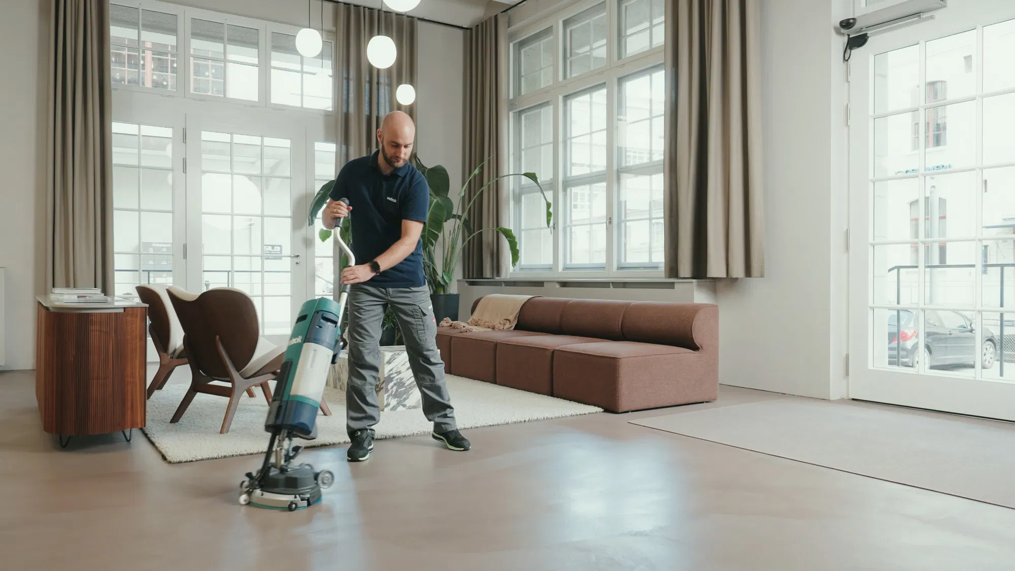 Person sitting on floor working on laptop